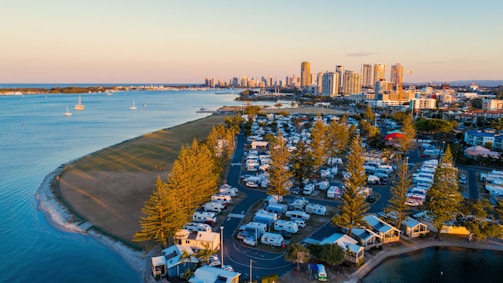Sunset view over a cozy seaside mobile home with a sparkling water park in the background