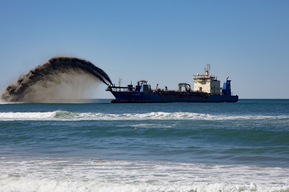 black ship on sea under blue sky during daytime