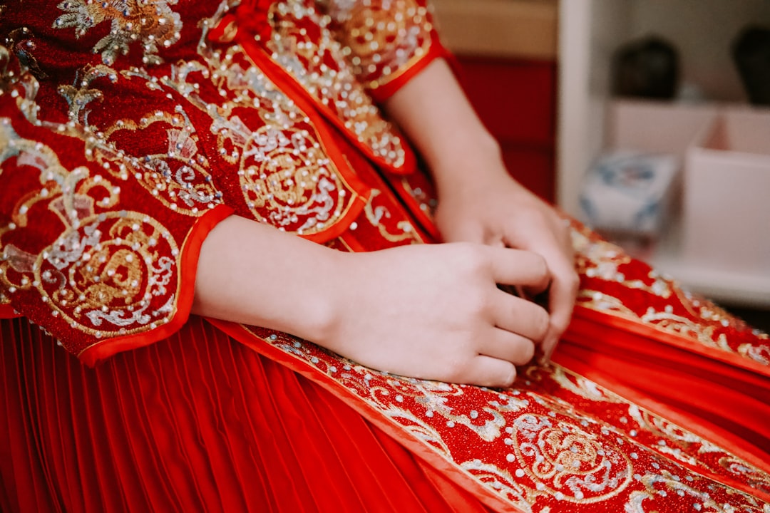 person in red and white floral dress