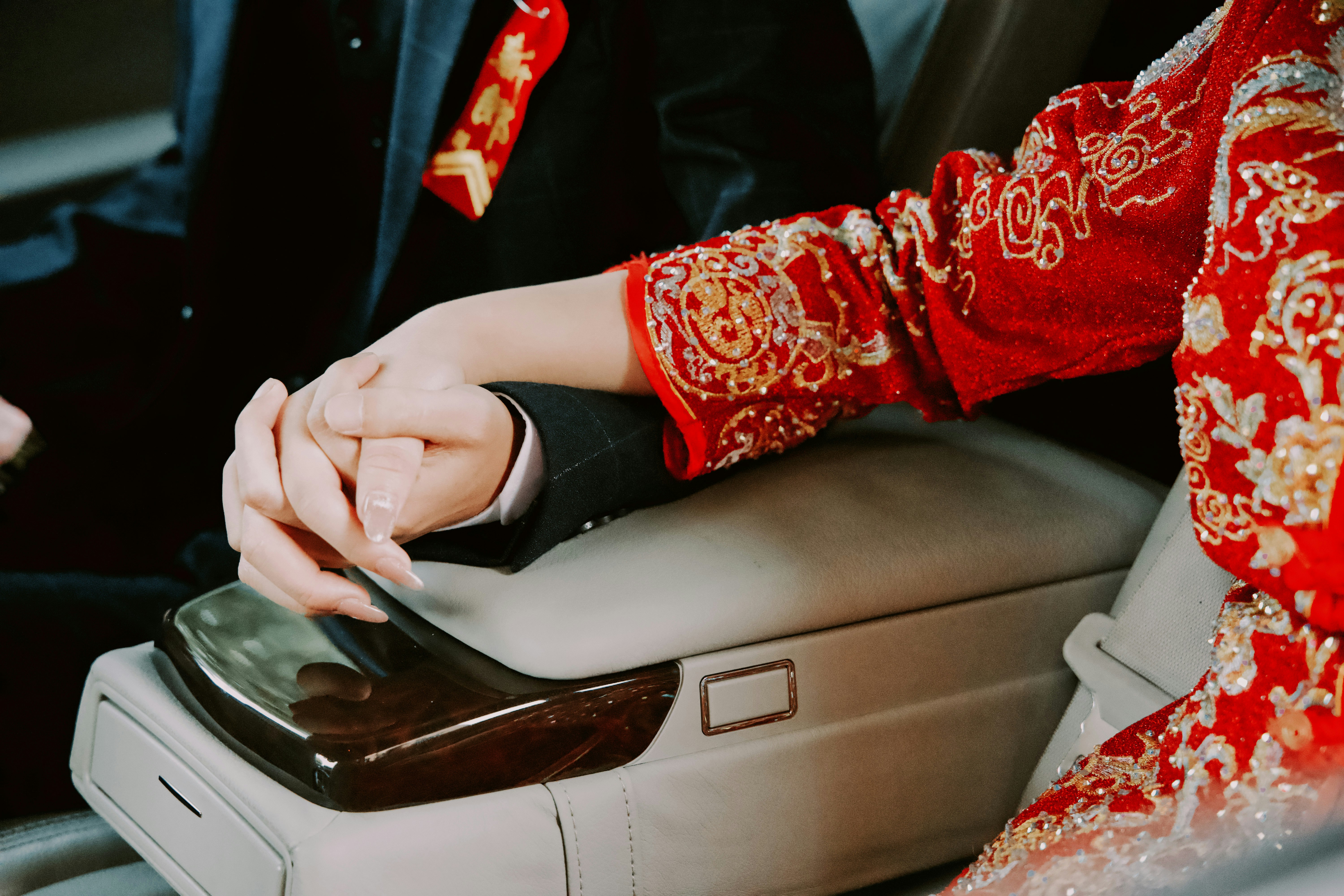 Smiling couple holding new car keys in a dealership after signing a lease