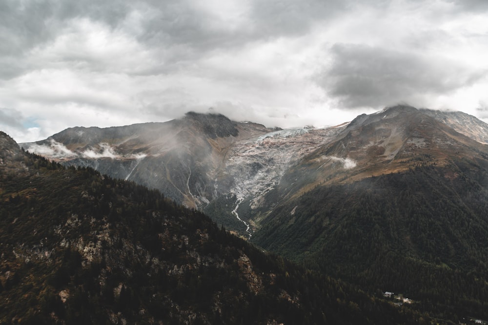 green and brown mountains under white clouds during daytime