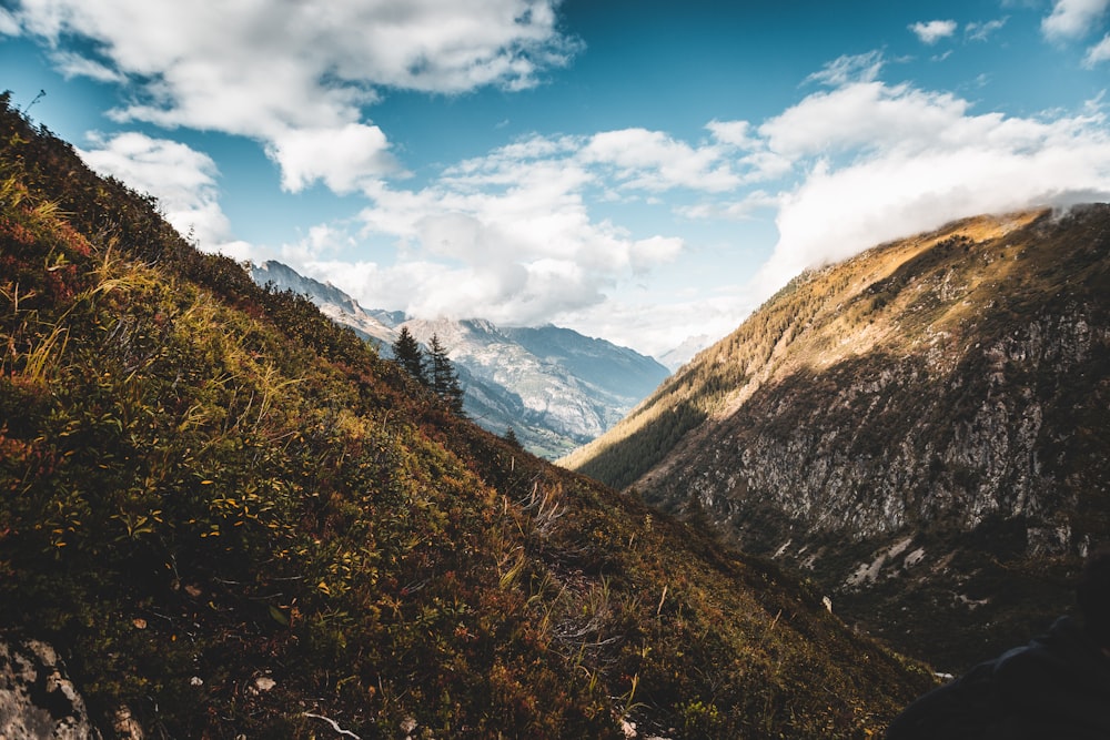 green and brown mountains under blue sky and white clouds during daytime