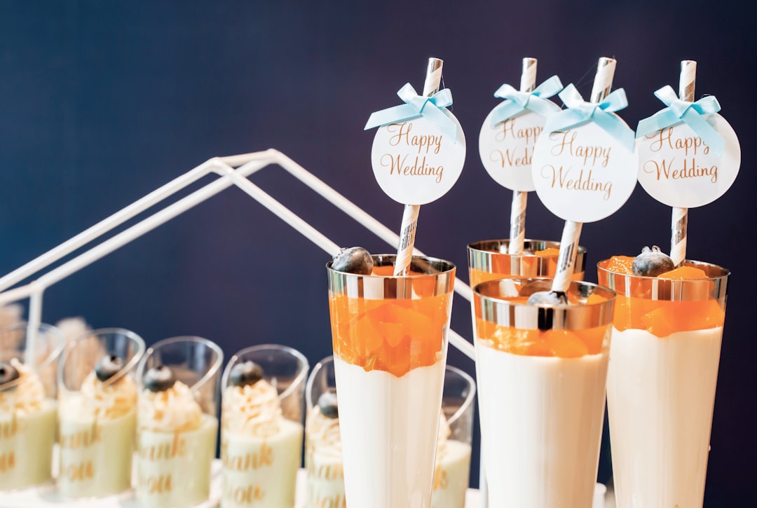 three clear drinking glasses with orange liquid