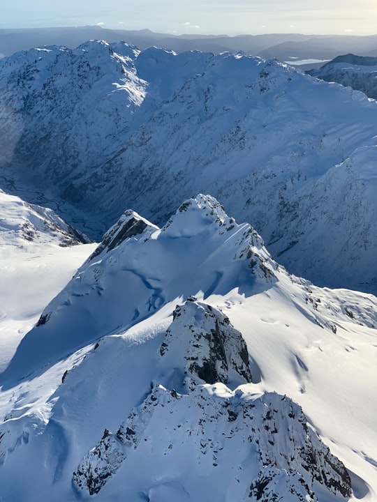 snow covered mountain during daytime in Westland Tai Poutini National Park New Zealand