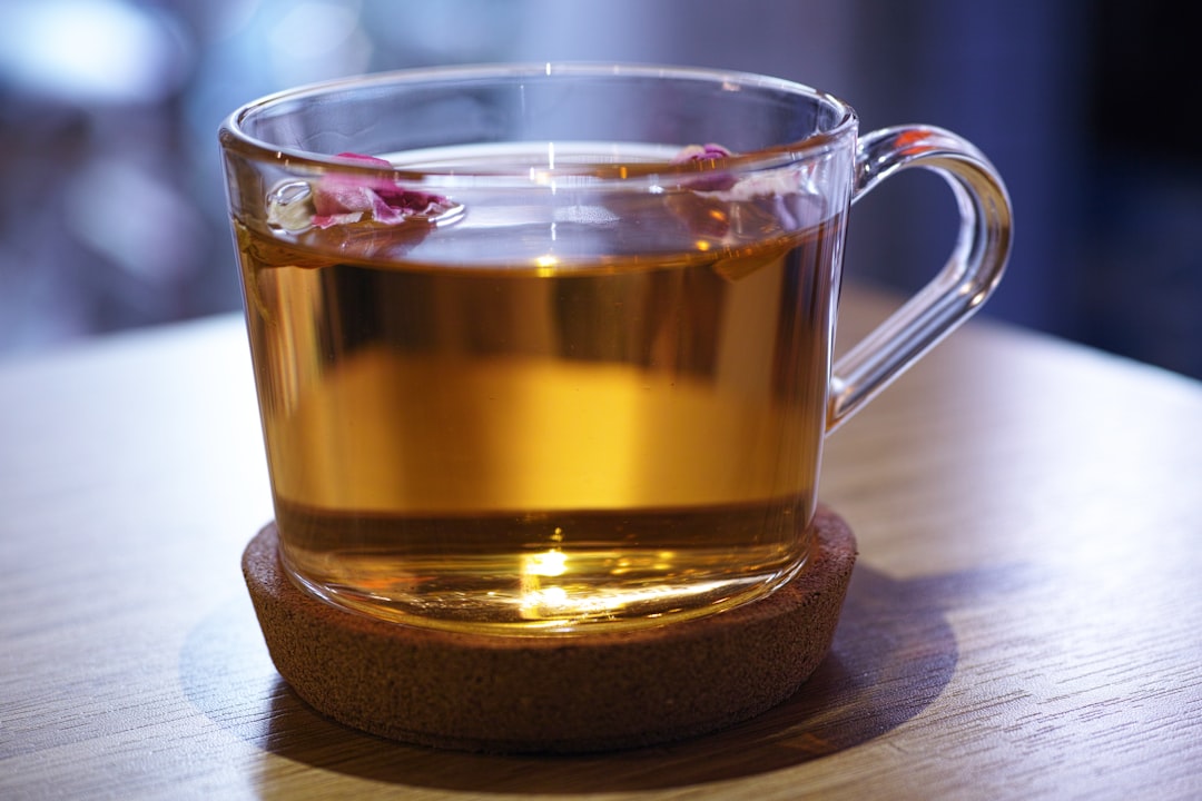 clear glass mug with brown liquid