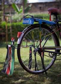 A customized mountain bike with colorful parts displayed outdoors.