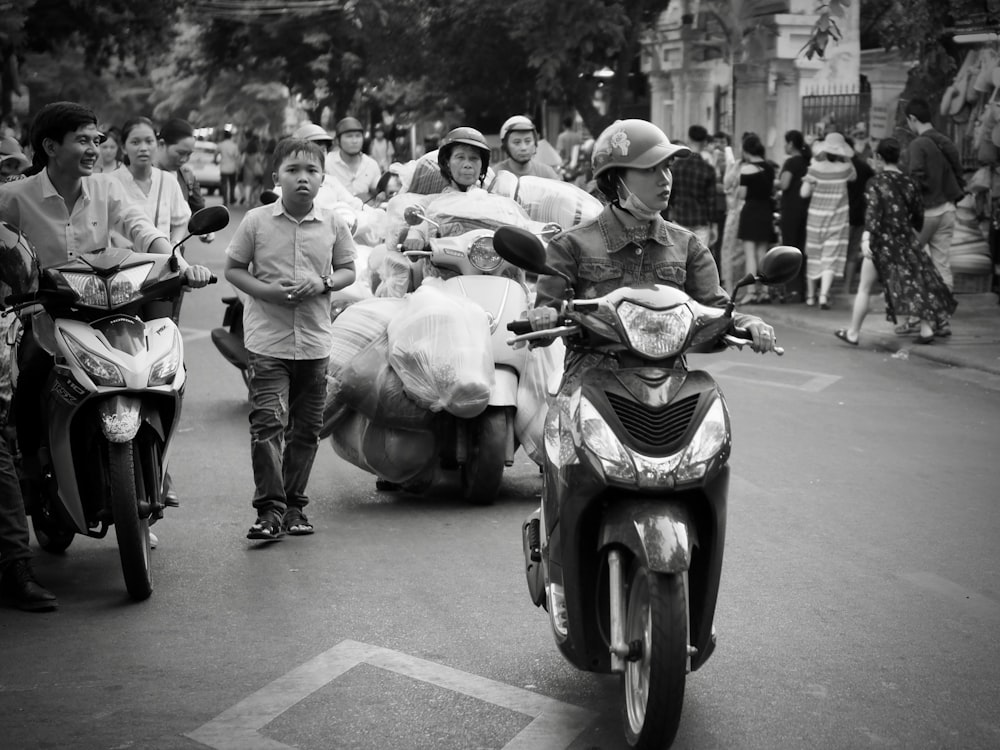 grayscale photo of people riding motorcycle