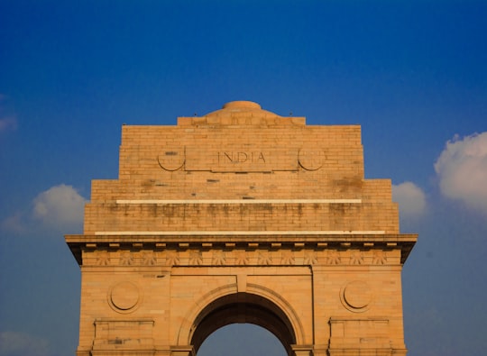 brown concrete building under blue sky during daytime in India Gate India