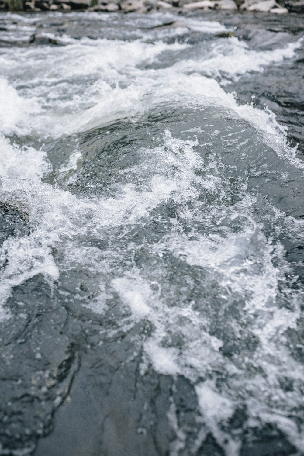 water waves on rocky shore during daytime