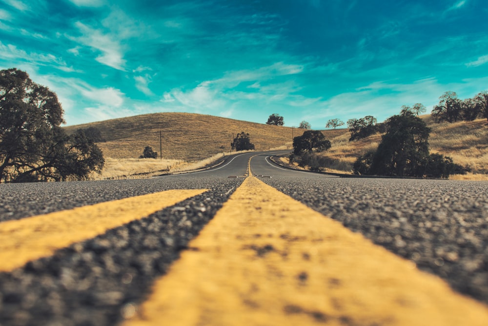 gray concrete road under blue sky during daytime