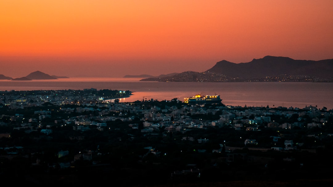 city skyline near body of water during night time