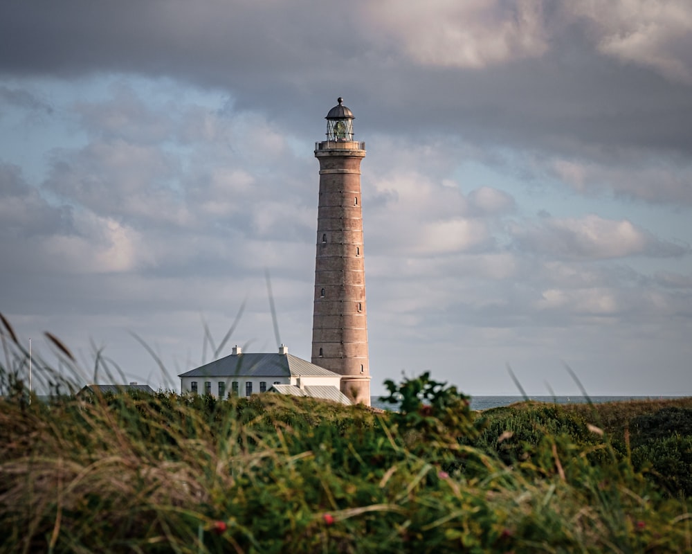white and brown lighthouse under cloudy sky during daytime