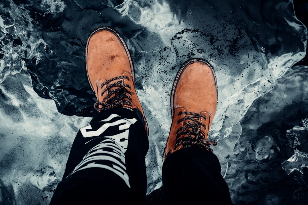 person in black and white pants and brown leather shoes