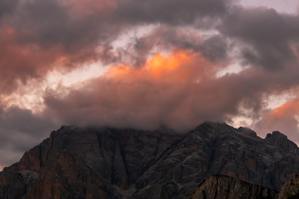 gray rocky mountain under cloudy sky during daytime