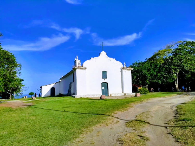 Colorful colonial houses and the historic church surrounding the Quadrado, the central village square of Trancoso, Bahia, Brazil.