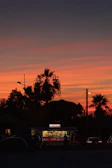 A cinematic frame capturing a food truck at sunset with glowing lights and customers.