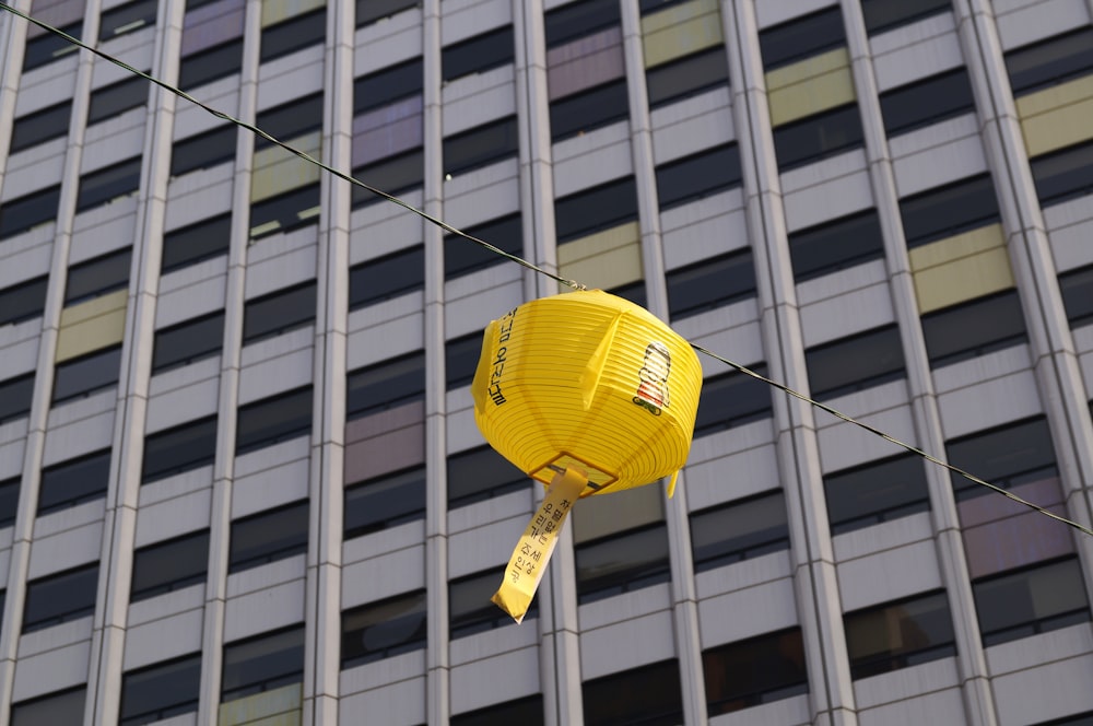 yellow paper lantern on glass building