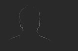 A haunting silhouette against a dark background.