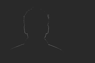 A haunting silhouette against a dark background.