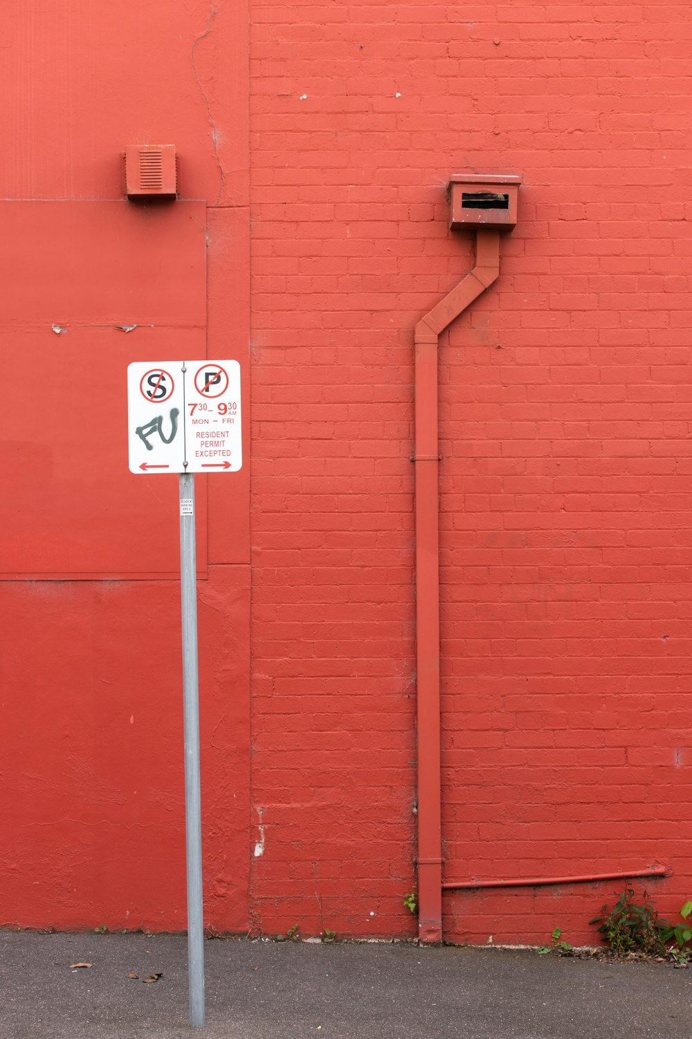 no smoking sign on red wall