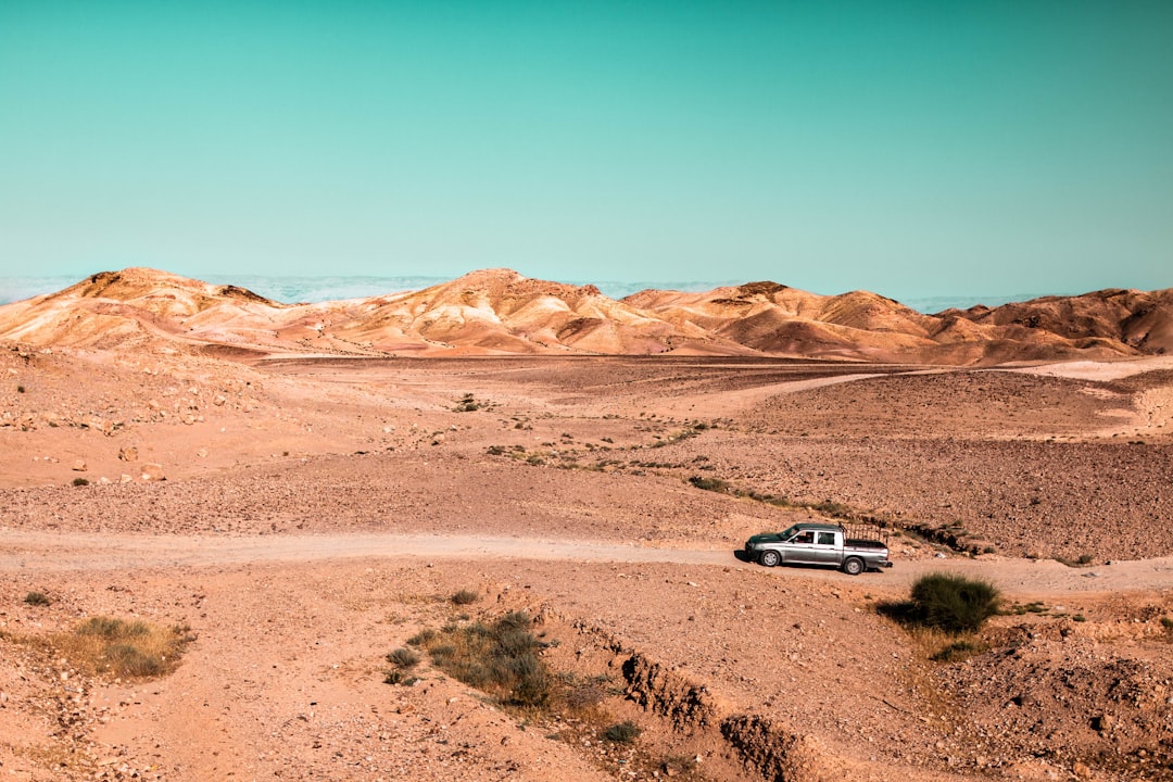 silver suv on brown sand