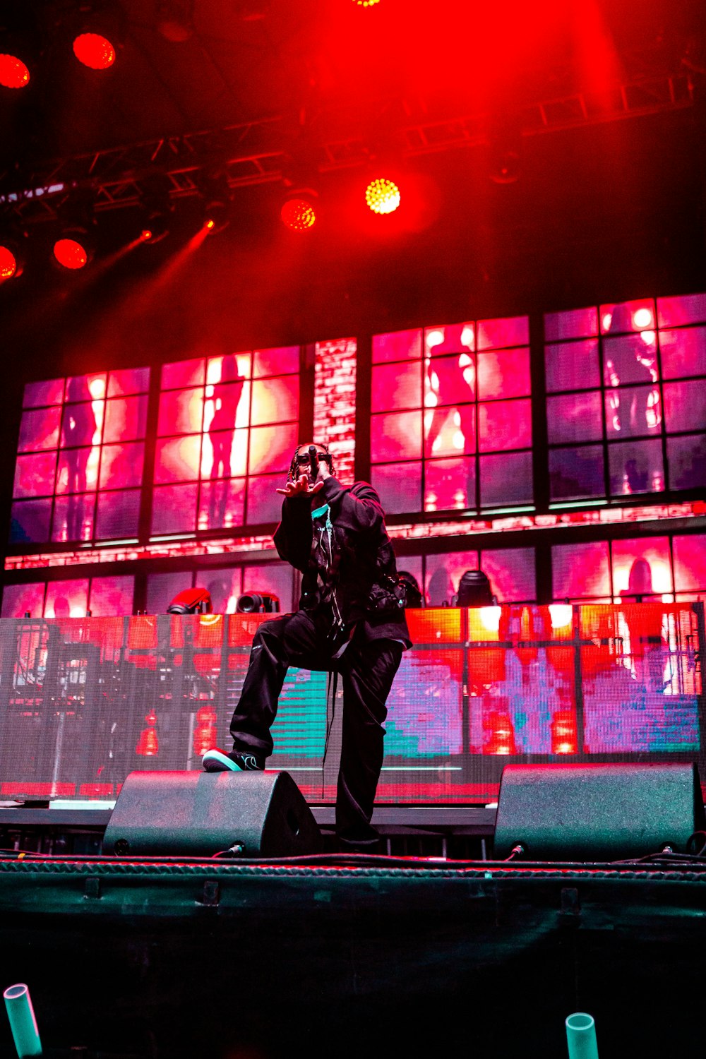 man in black leather jacket and black pants sitting on black chair