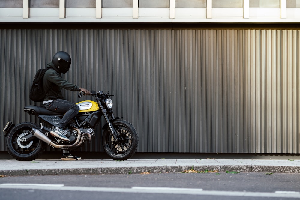 man in black jacket riding black motorcycle