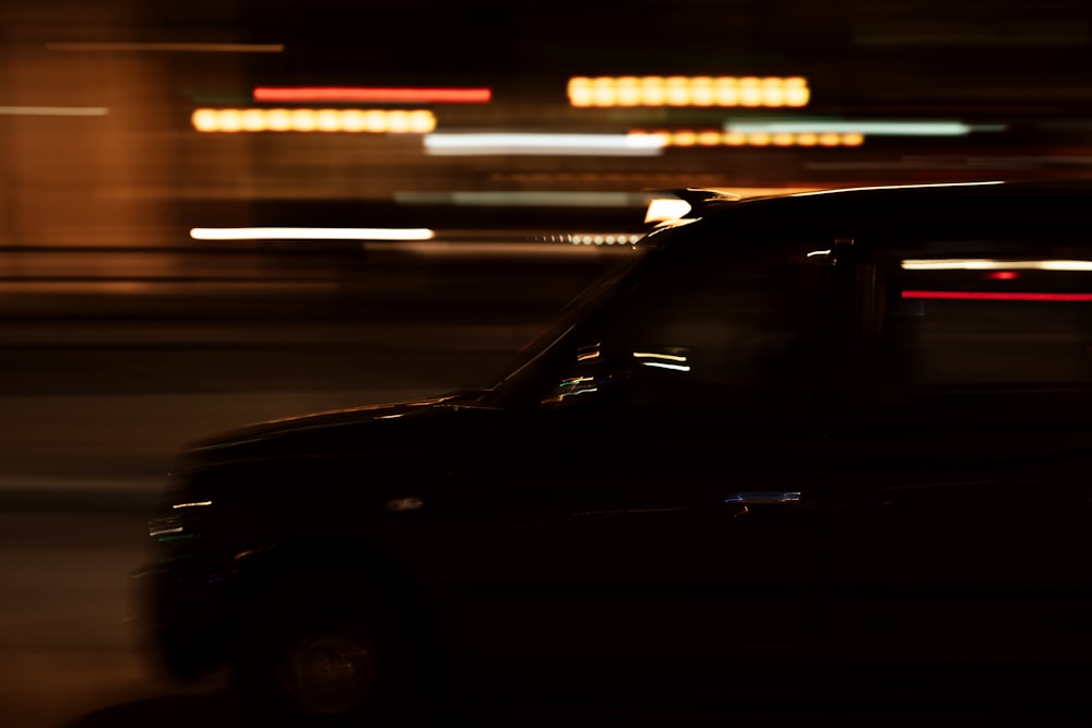 black car on road during night time