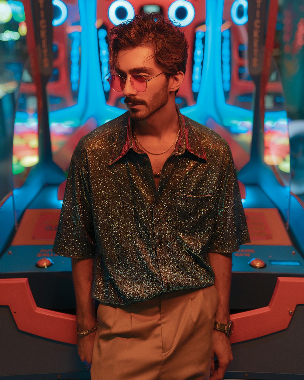 man in brown button up shirt standing near green and blue billiard table