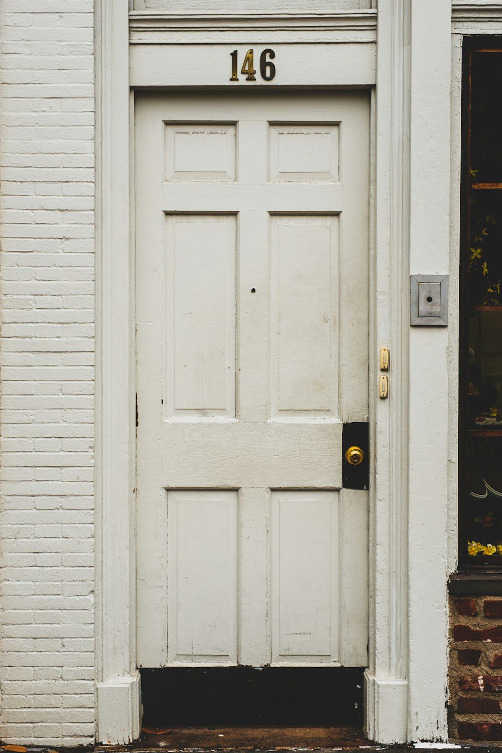 white wooden door with black wooden frame