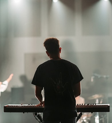 man in black crew neck t-shirt playing piano