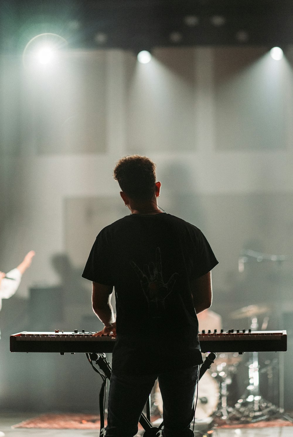 man in black crew neck t-shirt playing piano