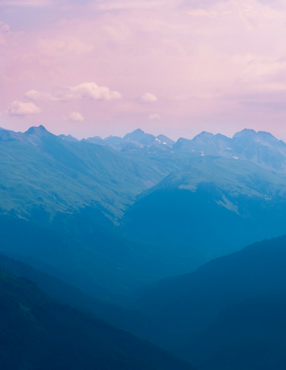 green mountains under white clouds during daytime