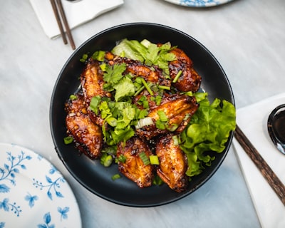 cooked food on black ceramic bowl dish google meet background