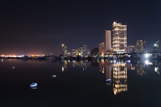 The dazzling Dubai Marina at night, lights reflecting on calm waters.