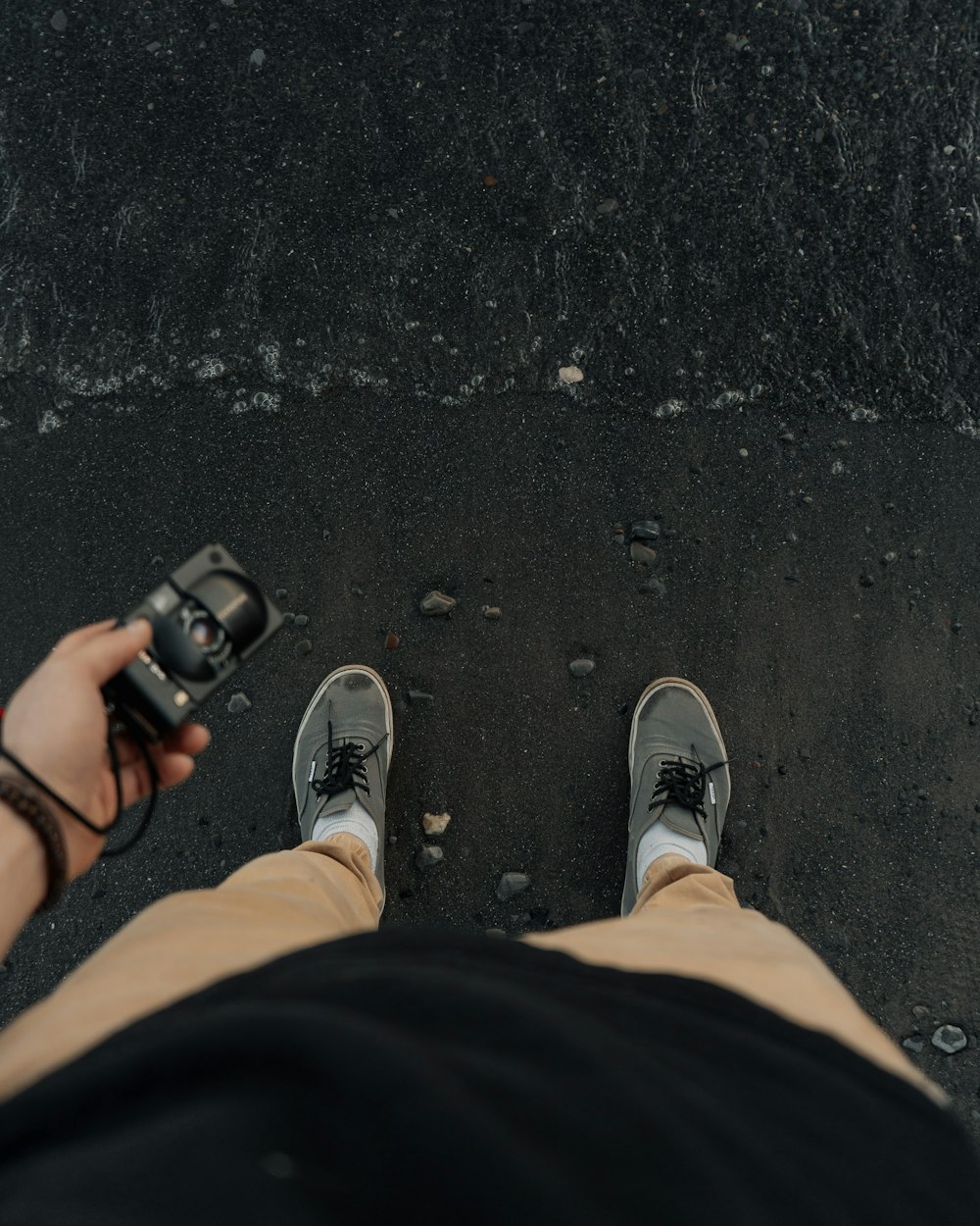 person in black pants and gray sneakers