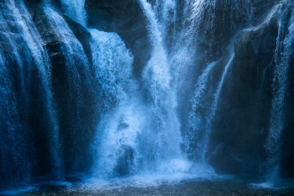 water falls in the middle of the forest