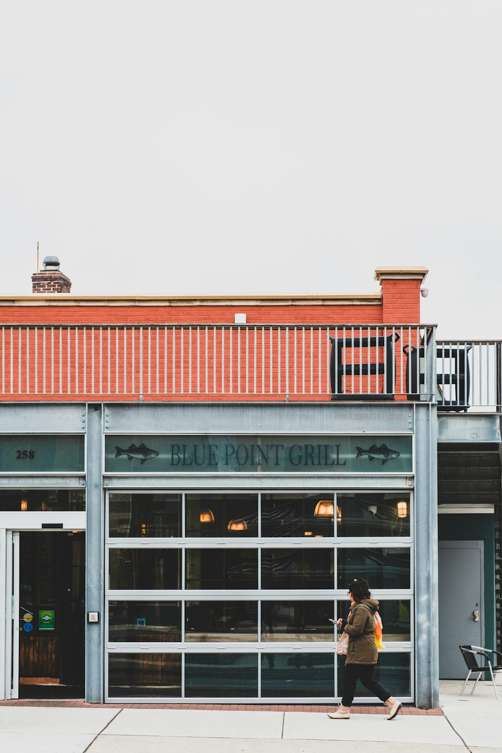 2 men standing in front of store during daytime