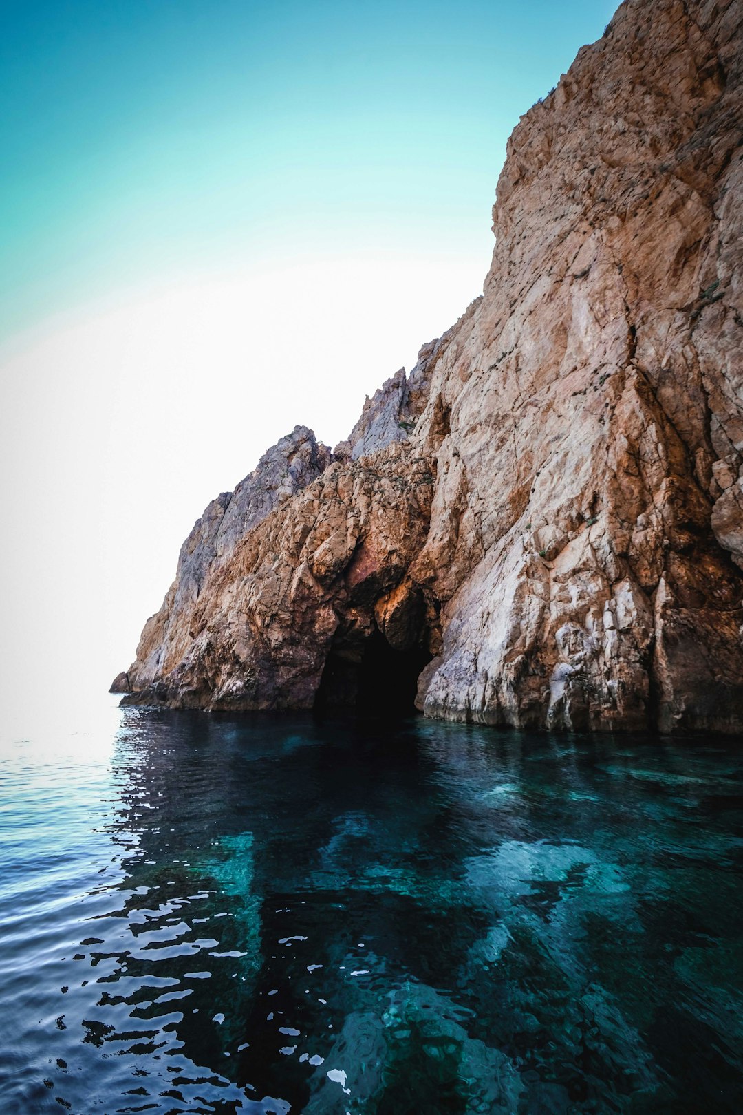 brown rock formation on blue sea during daytime