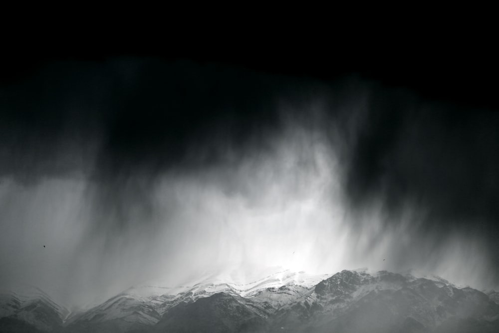 snow covered mountain under gray sky