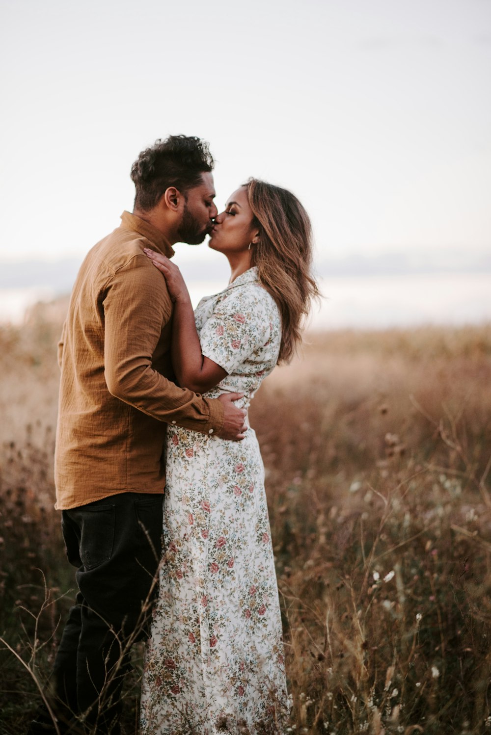 man and woman kissing during daytime