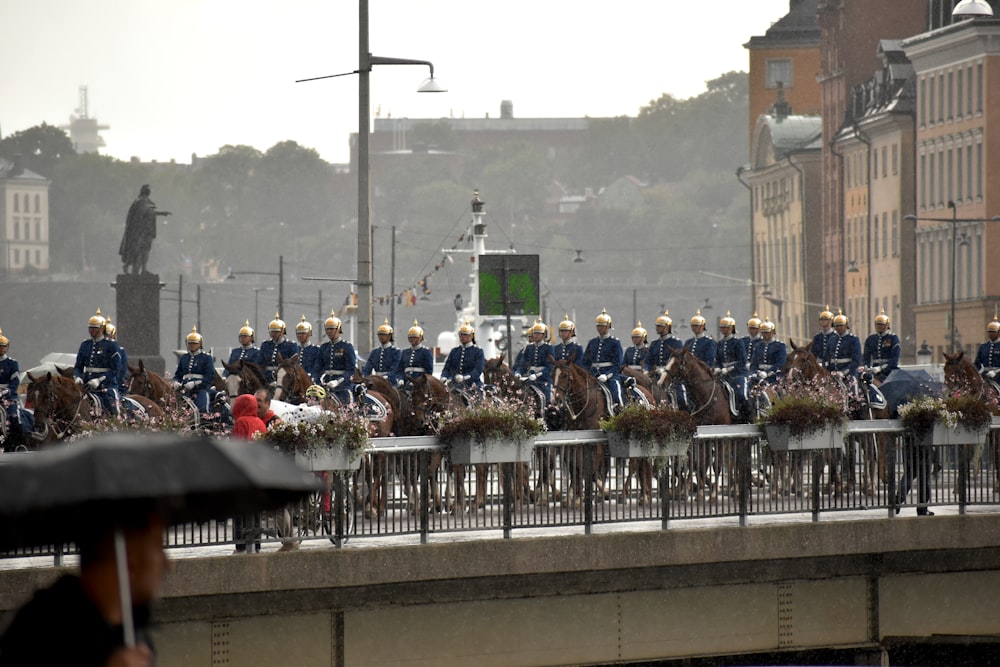 people on a bridge over a city with high rise buildings during daytime