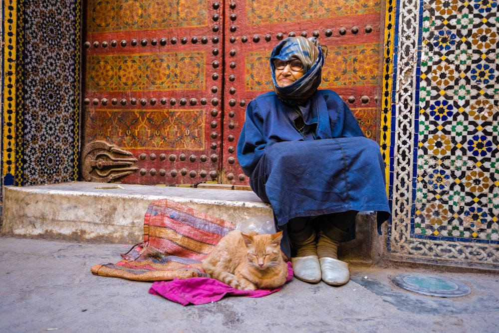 woman in blue long sleeve dress sitting on floor