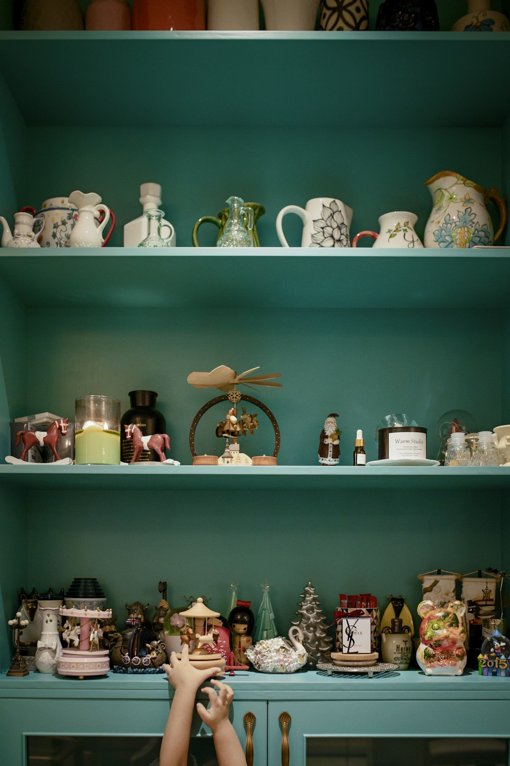 white ceramic tea set on green wooden shelf