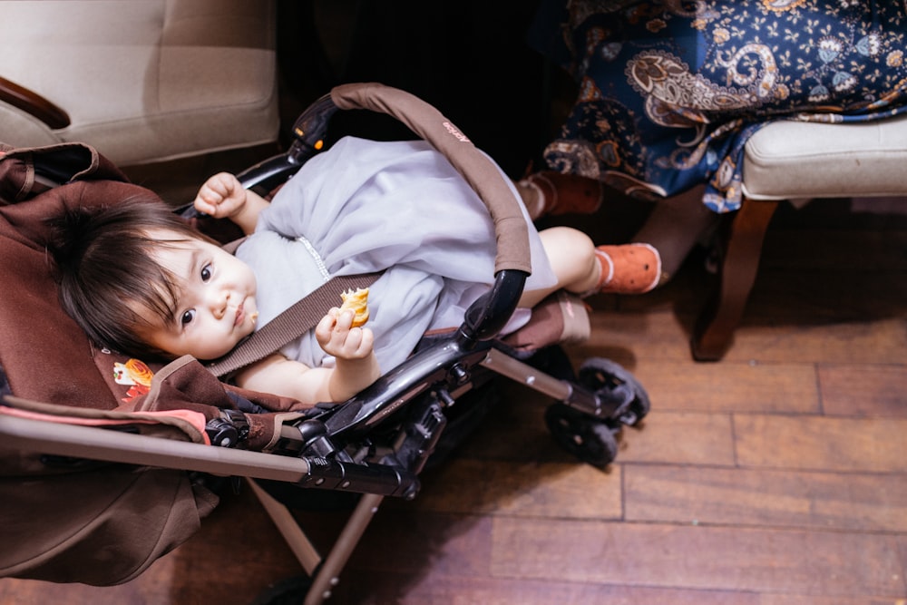 baby lying on stroller with baby