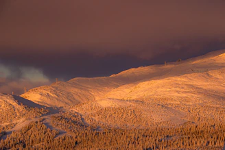 Sunrise casting golden light over the snowy peaks surrounding Saint Moritz lake