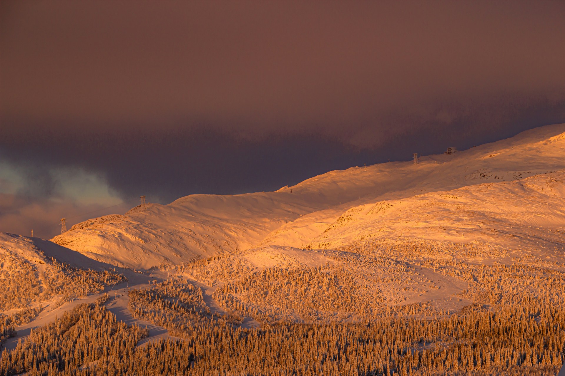 brown and green mountains under white clouds during daytime