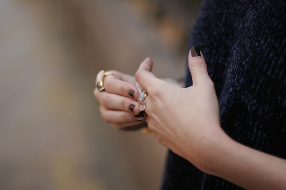 person wearing silver diamond ring