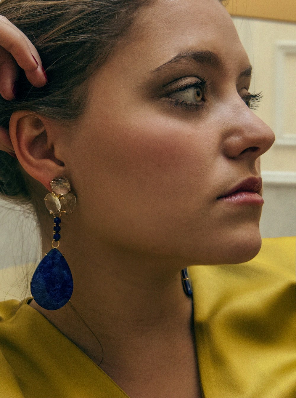 woman in yellow button up shirt wearing silver necklace