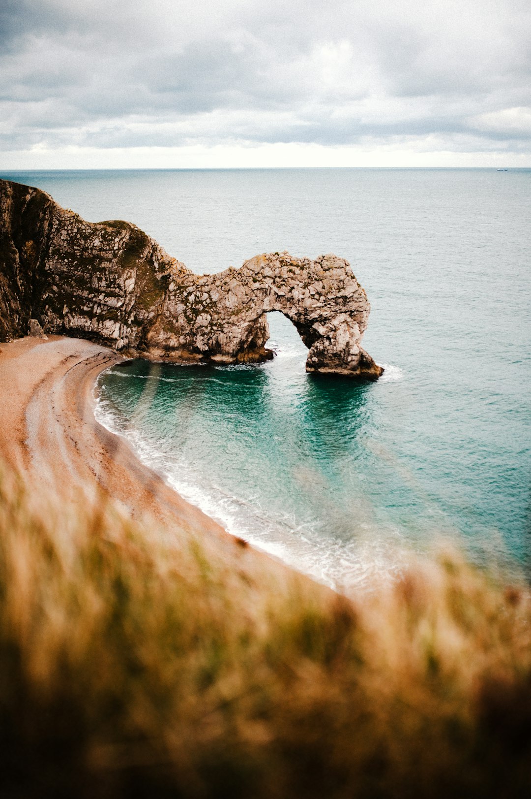 brown rock formation on blue sea water during daytime